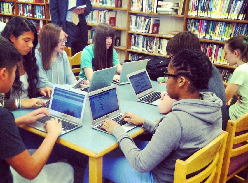 students at computers in library